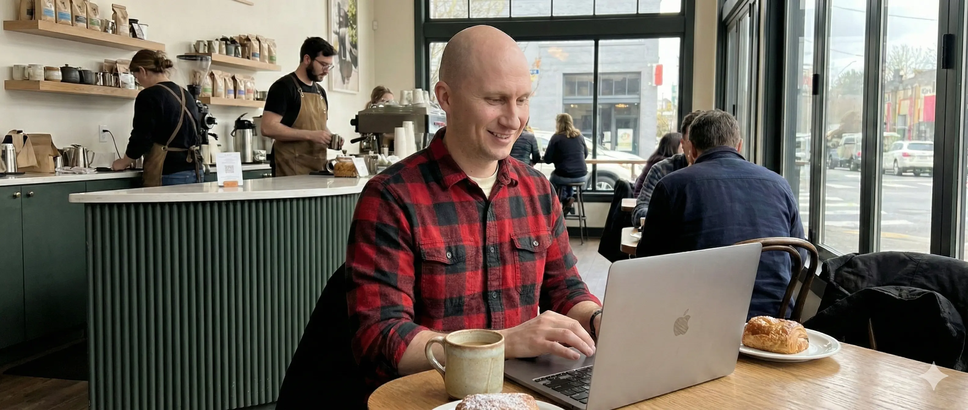 Matt Headley working on a laptop at a local coffee shop